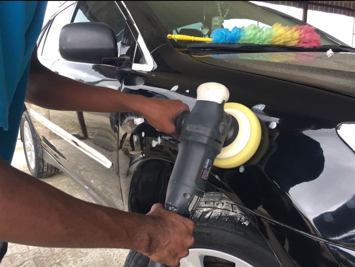 Refinish PHC technician machine polishing a car in Port Harcourt